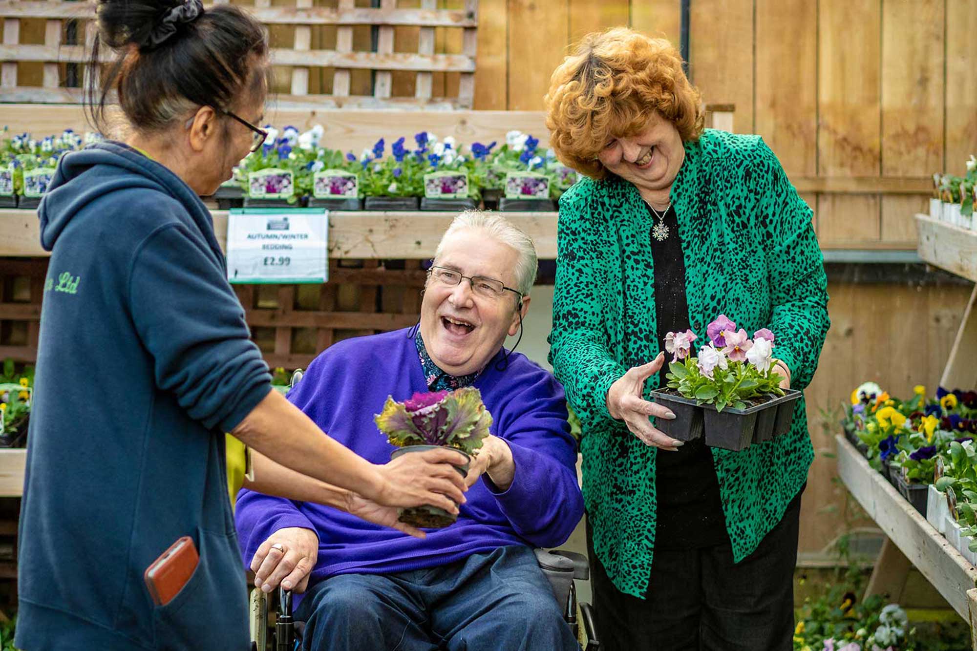 One of our dedicated Domiciliary Care Team assisting a client with their mobility & some shopping